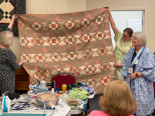 Seabeck, Bring & Brag Pajama Party - Mike M gives birthday quilt to Cathy W