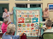 Seabeck, Bring & Brag Pajama Party - Cheryl S with sewing quilt